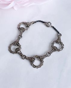 Lovely vintage bracelet from around the 1930s in a classic Art Deco style featuring decorative circles connected by filigree links.  Silver toned metal, spring ring clasp.  Good vintage condition with just a bit of patina on the chain commensurate with age.  Will fit a medium wrist comfortably. Victorian Jewelry With Oxidized Metal Finish, Victorian Oxidized Metal Jewelry, Antique Silver Metal Jewelry With Lobster Clasp, Intricate Metal Bracelet Jewelry, Ornate Antique Silver Metal Jewelry, Victorian Antique Silver Metal Jewelry, Victorian Antique Silver Jewelry, Victorian Metal Bracelet Jewelry, Vintage Silver Chain Link Bracelets