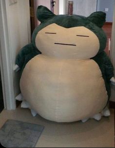 a large stuffed animal sitting on top of a floor