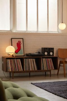 a living room filled with furniture next to a window covered in curtains and light bulbs