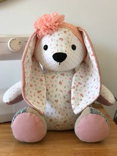 a stuffed animal sitting on top of a wooden table