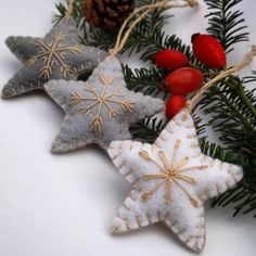 three ornaments are hanging from a christmas tree