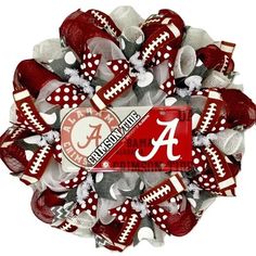 a wreath made out of red and white footballs with the letter a on it