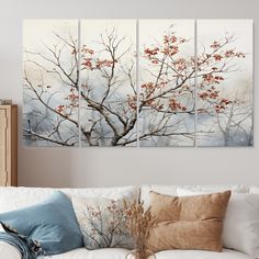 a living room with white couches and paintings on the wall