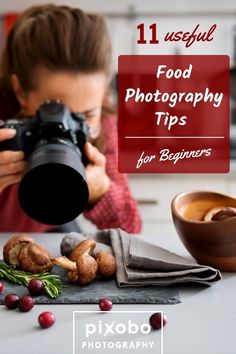 a woman taking a photo with her camera and food on the table in front of her