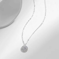 Enhance your style with our dazzling Olivia necklace, featuring a sparkling zircon pendant. Add a touch of elegance and glamour to any outfit with this eye-catching accessory. Elevate your look and make a statement with Olivia. Elegant White Gold Rhinestone Necklace For Parties, Cubic Zirconia Crystal Pendant Necklace With Clavicle Chain, Diamond White Rhinestone Necklace, Elegant Diamond White Necklaces With Rhinestones, Elegant Diamond White Rhinestone Necklace With Sparkling Stones, Elegant Crystal Clavicle Chain Necklace, Dainty Sparkling Necklace For Party, Glamorous Sterling Silver Necklace, Dazzling Rhinestone Necklace With Cubic Zirconia