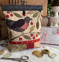 a bird on a branch with red berries and green leaves is sitting next to some buttons