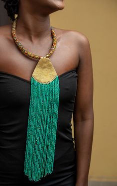 Unique African Maasai Handcrafted Beaded Necklace with an Elegant Look and Brilliant Finish. Color - Teal Blue and Mixed Color Beads. Length (Around Neck) = 17 Inches / 43 Centimeters. Length (Downwards) - 14.5 Inches / 37 cm. **GET FREE SHIPPING FOR ADDITIONAL ITEMS PURCHASED. Yes, Buy Multiple Items and pay shipping for 1 item only- The rest ships Free. (No Limits on the number of Multiple items). With a faster delivery time of 3 days via DHLExpress, Worldwide. Ordinary/Standard Shipping also Traditional Green Beaded Necklace For Festival, Traditional Green Beaded Necklace With Gold Beads, Traditional Green Beaded Necklaces With Dangling Beads, Traditional Green Beaded Necklace With Dangling Beads, Green Bohemian Beaded Necklaces, Artisan Green Dangling Beads, Green Artisan Dangling Beads, Green Polished Beaded Necklace For Festival, Artisan Green Necklaces With Dangling Beads