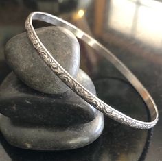 This listing is for one Sterling Silver Stacking Southwestern style floral Bangle Bracelet. This bangle is 3.55mm x 1.52mm thick and is sure to be a unique addition to your favorite stacking bangle bracelets! Lovely pattern All bangles are soldered, hammered, tumbled for hours and hand-polished just for you! My bangle sizes are available in the following sizes: Small - 2 1/4 inch diameter - Petite Adult 7 inch circumference Medium - 2 1/2 inch diameter - 8 inch circumference (common) Large - 2 3 Silver Bangles Design Silver Bangles Design For Women, Silver Bangle Bracelets Unique Modern, Southwestern Bangle Bracelet For Gift, Adjustable Etched Bangle, Adjustable Etched Round Bangle, Bohemian Etched Sterling Silver Bangle, Silver Bangle Bracelets Unique, Bangle Stacking, Silver Jewellry