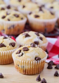 chocolate chip muffins sitting on top of a wooden table