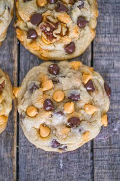 four cookies with chocolate chips and nuts on top