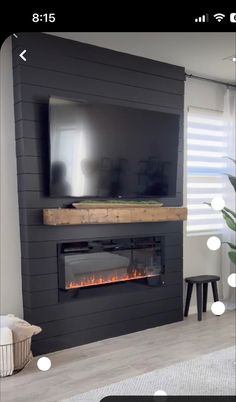 a flat screen tv mounted on the side of a wall next to a fire place