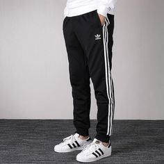 adidas originals Men's SST Track Pants in Black CW1275 (Casual/Stripe/Training) Adidas Relaxed Fit Bottoms For Jogging, Relaxed Fit Sportswear Pants With Three Stripes, Relaxed Fit Three Stripes Sportswear Pants, Three Stripes Relaxed Fit Sportswear Pants, Relaxed Fit Sportswear Bottoms With Three Stripes, Adidas Sportswear Pants For Spring, Adidas Relaxed Fit Sweatpants With Three Stripes, Adidas Relaxed Fit Athleisure Joggers, Casual Jogging Pants With Three Stripes Branding