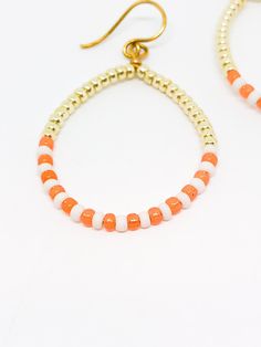 Handmade in Portland, Oregon. This will make the perfect gift! Or, definitely get it for yourself, I support that, too. MEASUREMENTS + MATERIALS - Length is about 1.5 inches - Color is a coral orange with white and gold accent seed beads - Gold plated for sensitive skin (hypoallergenic) - Other colors available! WHAT PEOPLE SAY “Beautiful craftsmanship, these were for my mother in law, she loves them. I love supporting small businesses.” - Josh “ Love these earrings!! I get so many compliments a Adjustable Orange Hoop Earrings, White Dangling Hoop Earrings With Colorful Beads, White Dangle Hoop Earrings With Colorful Beads, Orange Round Beads Jewelry For Everyday, Everyday Colorful Beads Orange Jewelry, Everyday Orange Round Bead Jewelry, Adjustable White Hoop Earrings With Colorful Beads, Adjustable Hoop Earrings With Gold Beads As Gift, Adjustable Gold Beads Hoop Earrings As Gift