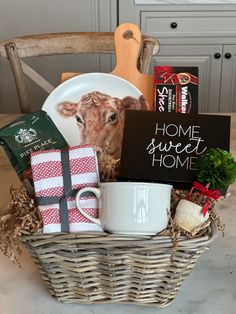 a basket filled with coffee, tea and other items sitting on top of a table