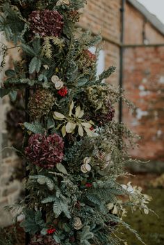 the wedding arch is decorated with greenery and flowers