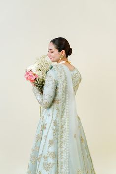 An embodiment of ethereal grace. A beautiful festive design in the captivating signature long panelled Agha Noor pishwas silhouette, crafted from pure soft organza heavily embellished with gold zardozi craftsmanship, each stitch is a testament to generations of artistry. Completing the Azeena masterpiece is a soft pure Gold Floor-length Kurta With Sheer Dupatta, Festive Naqshi Traditional Dola Silk Wear, Gold Salwar Kameez With Sheer Dupatta Floor-length, Embroidered Organza Gown For Diwali, Floor-length Raw Silk Dupatta With Naqshi Detail, Gold Floor-length Salwar Kameez With Sheer Dupatta, Transitional Organza Sharara With Zari Work, Gold Anarkali Kurta For Reception, Festive Naqshi Anarkali Set With Traditional Drape