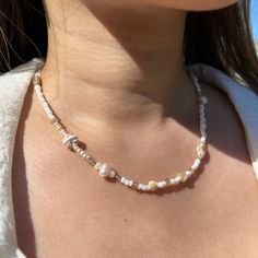 This handcrafted beaded necklace featuring cultured pearls is created for those who gravitate towards a neutral toned color palette. The beads are a mix of glass, polished shell, and cultured pearls, resulting a dazzling sparkle when they hit the light! The length of this necklace is adjustable from 16 in. - 18 in. - Beads are made of glass and polished shell - Features mini and large cultured pearls - Gold beads are gold filled - Jump rings, chain, and clasp are gold over stainless steel - Strung on stretch cord Please allow for slight variations in the item due to its handmade nature. Materials: Solare used gold plated stainless steel for our chains, jump rings, and clasps, which is a durable, tarnish resistant, skin sensitive metal - perfect for everyday wear. For our gold toned beads, Shells And Pearls, Rings Chain, Layered Beaded Necklaces, Pearl Beach, Black Pearl Necklace, Beach Necklace, Fruit Jewelry, Beach Necklaces, Beaded Anklets