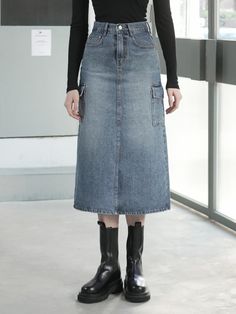 The item pictured is a denim skirt with a midi length and an A-line silhouette. The skirt features utility elements such as large patch pockets on the sides, which add to its practicality. It is designed with a high-waisted fit, judging from the length of the fly and the placement of the waistband. The construction includes a front closure likely consisting of a zipper and button, and the piece shows contrast stitching, which is characteristic of denim clothing.- The side patch pockets are both a functional and stylistic element, emphasizing the skirt's utilitarian design.- The A-line shape offers a flattering fit that may suit a variety of body types, providing comfort and ease of movement.- The midi length and high waist are classic elements that contribute to a timeless appearance, maki High-waist Denim Blue Skirt With Pockets, High Waist Denim Blue Skirt With Pockets, High Waist Denim Skirt With Pockets, Dark Wash Mid-rise Denim Skirt With Pockets, Mid-rise Dark Wash Denim Skirt With Pockets, Dark Wash High-waisted Skirt With Pockets, High Waist Dark Wash Skirt With Pockets, Knee-length Denim Skirt With Pockets, High Waist Utility Skirt With Pockets