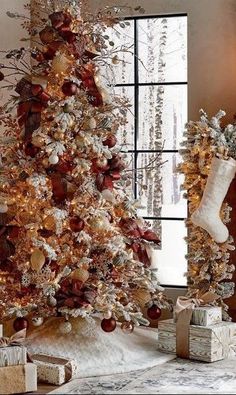 a decorated christmas tree in front of a fireplace