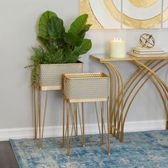 two planters sitting next to each other in front of a table with a candle on it