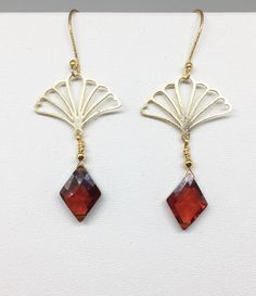 "Lovely gold Vermeil earrings with red Cubic Zirconia (CZ). These earrings evoke the romantic style of a bygone era known as the 1920's where Art Deco design was all the rage! The Vermeil fan shape is both feminine and stylish with a clear red CZ gemstone that is faceted and cut into a diamond shape that enhances its pure red color! Simply stunning, you will not go unnoticed while wearing these beauties. Perfect for your next holiday event or any other occasion. These earrings are light weight a Red Chandelier Earrings For Formal Events, Formal Red Chandelier Earrings, Antique Brass Earrings For Party, Antique Nickel-free Earrings For Party, Yellow Gold Pierced Crystal Earrings For Gift, Yellow Gold Pierced Crystal Earrings As Gift, Pierced Yellow Gold Crystal Earrings As Gift, Elegant Christmas Celebration Jewelry, Art Deco Brass Jewelry With Matching Earrings