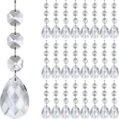 a set of silver and clear crystal glass beaded necklaces hanging from chains, on white background