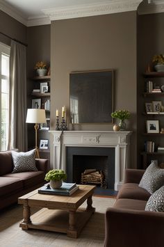 a living room with two couches and a coffee table in front of a fireplace