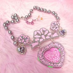 The Opulent necklace ~ inspired by those 80's magic key Clarkes shoes (you know the ones!) with a pink butterfly engraved illustration on iridescent rainbow acrylic ~ comes on a silver pearl chain with lilac crystal heart embellishments and a silver metal finish Main Charm size (inlcuding bow): 6 x 8cm Necklace length : 36cm, Extender 6cm Hand made and hand-illustrated with love in the UK Fairy Kei Silver Jewelry Gift, Silver Fairy Kei Jewelry Gift, Silver Fairy Kei Jewelry For Gifts, Cute Butterfly Necklace For Gift, Harajuku Style Silver Necklace For Gift, Pink Butterfly Charm Necklace For Party, Pink Butterfly Necklace For Party, Pink Handmade Fairy Kei Jewelry, Handmade Pink Fairy Kei Jewelry