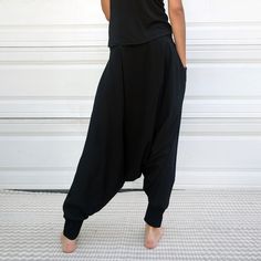 "Black Samurai Style Ninja Pants for Women and Men. This Stretch Cotton Harem Pants Fit Plus Size. -Unisex -Stretch -Flowing relaxed fit -Inner drawstring to secure the waist -2 side pockets Great for Yoga, Dance, Exercises, Meditations, Yoga Practice and beyond... Materials: black color cotton blend (90% cotton 10% lycra). Fabric for this pair were bought in Fashion District, LA and the pant was made in one of the studios in Los Angeles, CA. Measurements: Fits: S, M, M/L -Length: 41\" (~102 cm) Solid Color Harem Bottoms With Pockets, Baggy Solid Color Yoga Trousers, Solid Color Baggy Yoga Trousers, High Waist Harem Pants With Pockets For Yoga, High Waist Harem Yoga Pants With Pockets, Black Full Length Yoga Pants With Elastic Waistband, Black Full-length Yoga Pants With Elastic Waistband, Solid Color Harem Pants With Pockets, Solid Harem Pants With Pockets