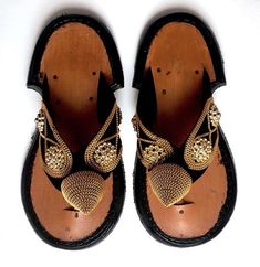 This is a beautiful Ghanaian Traditional Slipper. Ahenema is the local name for this Traditional Ghanaian Men’s pair of Slippers. It is a local sandal usually used by chiefs, queens, elderly people in the society and the rich or well-to-do in society. It is the royal footwear of the Akan and symbolizes pure elegance and class. It is worn during traditional events like festivals, funerals, marriage ceremonies and also worn for church functions in modern times. Gala Sandals With Single Toe Strap, Gold Closed Toe Sandals For Galas, Traditional Festival Sandals With Leather Sole, Traditional Leather Sole Festival Sandals, Traditional Closed Toe Leather Sandals, Traditional Black Sandals With Single Toe Strap, Festival Sandals With Leather Sole And Single Toe Strap, Traditional Black Closed Toe Sandals, Traditional Leather Sandals With Single Toe Strap