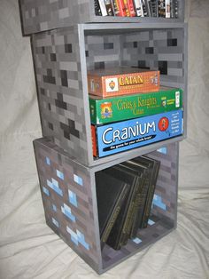 a book shelf made out of lego blocks with books stacked on top of each other