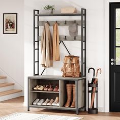 a coat rack with shoes and umbrellas on it next to a stair case in a room