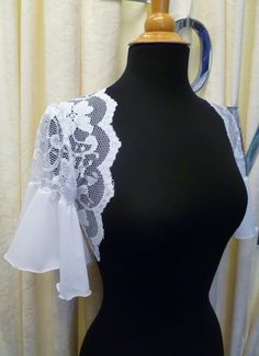 This on of a kind bridal shrug bolero has been made with white chiffon and stretch white lace fabric. This stunning piece is the perfect solution to add a romantic shabby chic look to any outfit . Lightweight super soft material.White only. Very simple and beautiful addition to any outfit. UK Size 10 -14 US Size 8 -12 Chest 32- 36 Any questions please contact me Thanks Sally x Please allow 1-2 weeks to receive your item from time of purchase if posting overseas sent by Royal Mail Airsure. If pur Fitted Sheer Lace For Wedding Night, Fitted White Lace For Wedding Night, Fitted Lace Shrug With Lace Trim, Fitted White Lace For Mother Of The Bride, Stretch Lace With Lace Trim For Wedding, Elegant Stretch Lace For Wedding, Wedding Lace With Stretch, Lace Shrug With Lace Trim For Wedding, Wedding Shrug With Lace Sleeves