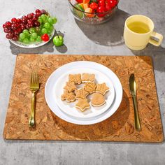 there is a plate with cookies and fruit on the table