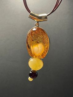 A ball of butterscotch amber looking like a fluffy rabbit tail wrapped inside a piece of 3A's super clear cognac amber formed this rare piece of jewel. The design is completed with two other butterscotch amber and one blood amber beads. Pendant height: 77.1 mm Pendant width: 26.4 mm Pendant thickness: 23.7 mm Necklace length: 450 mm with extender  Weight: 24.41 g ABOUT OUR PRODUCTS All our ambers are 100% natural, not in any way enhanced. Every item in our shop are handmade with love and happy v Luxury Citrine Amber Necklace, Luxury Amber Gold-plated Jewelry, Luxury Amber Citrine Necklace, Luxury Amber Necklaces With Gemstone Accents, Luxury Amber Oval Necklaces, Luxury Amber Necklace For Formal Occasions, Cheap Amber Necklaces, Luxury Amber Necklaces Fine Jewelry, Luxury Amber Necklaces With Large Pendant