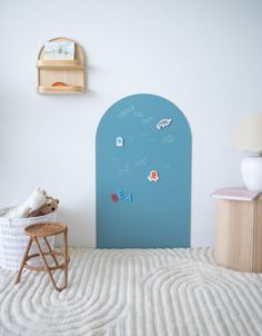 a child's room with a blue wall and white carpet