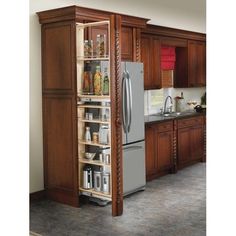 a kitchen with wooden cabinets and stainless steel refrigerator freezer next to an open pantry door