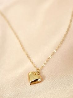 This necklace features a brass-plated puff heart charm on an 18" gold-filled chain. Crafted from premium materials including gold-filled chain and a brass heart charm, this necklace is sure to make a statement. Length: 18" long 14k Gold-filled Heart Necklace With Heart Charm, Dainty Heart-shaped Brass Jewelry, Valentine's Day Heart Necklaces With Gold Chain, Valentine's Day Gold Chain Heart Necklace, Valentine's Day Heart Necklace With Gold Chain, Valentine's Day Heart Shaped Gold Chain Necklace, Everyday 14k Yellow Gold Filled Heart Necklace, Minimalist Gold Plated Heart Charm Necklace, Everyday Gold Plated Heart Charm Necklaces