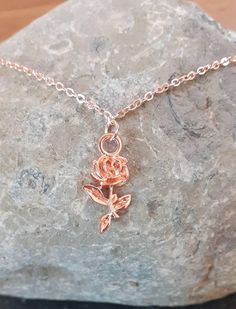 Really pretty delicate rose gold coloured necklace with flower pendant. Made from rose gold plated flat cable chain, 43 cm and can be extended with 5cm of extendable chain.  The pendant is a pretty rose pendant which is made from a rose gold coloured alloy, size 10.5mm wide, 21mm long and 2.5mm thick.  All lead and nickle safe. Keep made moisture free and wipe with a soft cloth after each use to maintain shine.  Comes packaged in a gift box. Delicate Rose Gold Flower Charm Necklace, Delicate Rose Gold Charm Necklace With Flower, Elegant Rose Gold Flower Charm Necklaces, Elegant Rose Gold Flower Charm Necklace, Rose Gold Flower Pendant Clavicle Necklace, Rose Gold Clavicle Chain Necklace With Flower Pendant, Rose Gold Necklace With Flower Pendant, Rose Gold Flower Pendant Necklace With Roses, Rose Gold Necklace With Flower Pendant And Roses