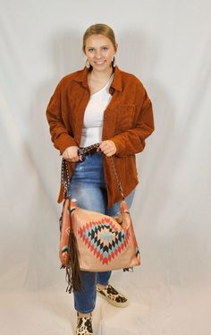 This shoulder strap purse is 17" by 13" with a detailed leather strap and removable fringe accents. It zips closed and has interior pockets. Casual Fringe Shoulder Bag For Everyday Use, Fall Hobo Bag With Adjustable Strap, Bohemian Satchel Bag For Fall, Fringe Bags For Everyday Use In Fall, Fall Fringe Shoulder Bag For Daily Use, Brown Fringe Bag For Fall, Fringe Hobo Bag For Daily Use In Fall, Fringe Hobo Shoulder Bag For Everyday Use, Bohemian Bags With Adjustable Strap For Fall