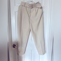 Elevate Your Wardrobe With These Stylish High-Waisted Pants From Zara. Perfect For Any Occasion, These Pants Feature A Solid Pattern And A Cream Color That Complements Any Outfit. The Pants Are Made Of Polyester Material And Have A Pleated Front Type, A Classic Fit, And A Straight Leg Style. The Pants Come With A Fabric-Covered Belt That Adds An Extra Touch Of Elegance To The Outfit. The Belted Feature Is Perfect For Travel, Party/Cocktail, Casual, And Business Occasions. These Pants Are Availab Belted Beige Trousers, Belted High-waisted Pants For Spring, Spring Workwear Dress Pants With Belt Loops, Trendy Pants With Belt Loops For Day Out, Spring High-waisted Belted Pants, Spring Dress Pants With Belt Loops For Work, High Waist Beige Belted Pants, Cream Straight Pants With Belt Loops, Belted Straight Leg Beige Pants