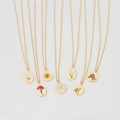 "These beautiful and dainty flower collection disk necklaces are made from 18ct gold plated metal, the pendants show different designs, choose your favorite flower your heart desires.. This is the perfect gift for you and your loved ones.❤ D E T A I L S * Delicate floral designs on circle or oval shaped disks * Each flower indicates; ▸ Lily (oval): purity & devotion ▸ Carnation (oval): love & gratitude ▸ Sunflower: loyalty & good fortune ▸ Daisy: hope & peace ▸ Tulip (oval): perf Charming Gold Flower Pendant Jewelry, Delicate Charm Necklace With Flower Pendant, Delicate Flower Charm Round Pendant Necklace, Delicate Charm Necklace With Round Flower Pendant, Delicate Round Pendant Charm Necklaces With Flower Charm, Dainty Round Pendant Flower Necklace With Flower Charm, Dainty Round Flower Charm Necklace, Mother's Day Dainty Flower Charm Necklace, Dainty Flower Charm Necklace For Mom