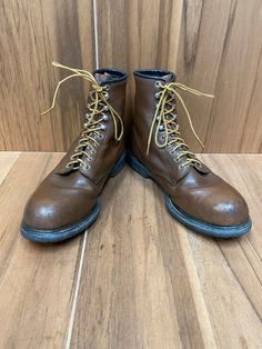 "Vintage 90's Red Wing steel toe work boots style #2233, size 11D, color brown, electrical hazard supersole. Good condition some wear, made in U.S.A.  Please check the measurements before purchase, we do not accept returns or exchanges.   Outsole Approximate Dimensions: 13\" long heel to toe. 11 1/2\" Inside from the heel to the toe. 4 1/2\" Widest wide in front of footwear. 1\" Tall heel. 8\" Tall total. Let me know if you have any questions or would like to see additional photos. International Streetwear Work Boots With Vibram Sole And Plain Toe, Streetwear Work Boots With Vibram Sole, Plain Toe Work Boots With Vibram Sole For Streetwear, Rugged Plain Toe Work Boots For Streetwear, Rugged Work Boots With Plain Toe For Streetwear, Steel Toe Work Boots For Streetwear, Brown Sturdy Work Boots For Safety, Steel Toe Work Boots With Plain Toe, Rugged Work Boots For Streetwear