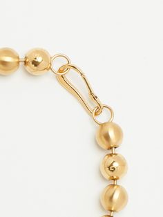 The Sphere Collection is a combination of eco-friendly brushed gold solid spheres & a polished hollow spheres with the Bagatiba Scattered logo engraved lightly. This collection is also made in very small quantities to ensure you're getting a unique item just like the spheres themselves. Material: Stainless Steel / Brushed Gold & Gold Plated Dimensions: 17" necklace + 1" Clip. 13mm across sphere. Weight: .8 oz - this necklace is heavy. Eco-Friendly. Modern Gold Ball Chain Jewelry, Matte Gold Round Jewelry With Polished Finish, Modern Ball Chain Jewelry Gift, Formal Metal Jewelry With Ball Chain, Adjustable Gold Ball Chain Jewelry, Round Brass Jewelry With Gold Beads, Modern Gold Orb Jewelry, Orb-shaped Gold Jewelry For Gift, Yellow Gold Round Ball Chain Jewelry