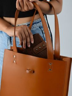 Embrace pure elegance with our artisan-crafted shopper tote. Woven from the very soul of buffalo leather, it doesn't just carry your belongings, but your style and confidence too. Its timeless brown shade, a silent nod to tradition, blends seamlessly with its contemporary design. Grasping the handles feels like shaking hands with timeless luxury. Revel in life's small moments of grandeur with every step, showcasing the world that you have an impeccable taste for both fashion and life's pleasures Brown Double Handle Shoulder Bag For Everyday, Brown Satchel With Leather Handles For Shopping, Brown Tote-shaped Bucket Bag For Daily Use, Brown Bucket Tote Bag For Daily Use, Brown Tote Bucket Bag For Daily Use, Classic Brown Bucket Bag With Double Handle, Brown Top Handle Bucket Bag For Everyday Use, Chic Brown Bucket Bag With Leather Lining, Brown Top Handle Shoulder Bag For Everyday