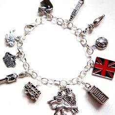 This charm bracelet features London inspired Tibetan silver charms (nickel free). The charms are attached to a silver tone 7.5 inches chain bracelet. Cheap Nickel-free Spiritual Charm Bracelet, Symbolic Charm Bracelet With Dangling Charms, Silver Symbolic Bracelets With Dangling Charms, Symbolic Silver Bracelets With Dangling Charms, Symbolic Silver Bracelet With Dangling Charms, Symbolic Dangle Charm Bracelet, Themed Silver Metal Charms, Nickel-free Sterling Silver Symbolic Charm Bracelet, Nickel Free Silver Themed Charms