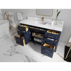 a bathroom with marble counter tops and blue drawers on the sink area, along with gold accents