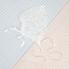 Handmade in the USA This sheer lace bonnet is the perfect accent for any special event or day! Made with the same floral netting lace as the Ella romper dress, using the scalloped edge of the lace to make a lovely frame for baby's face! Silk ribbon ties can be used to secure the bonnet on baby, and a tie on the back can be used to adjust the fit, to make it just right for her! Light ivory floral embroidered netting lace Ivory Venice lace Ivory silk satin ribbon Fitted Scalloped Lace For Ceremony, Fitted White Bonnet With Lace Trim, Elegant Lace Bonnet With Lace Trim, Adjustable Lace Wedding Bonnet, Fitted Delicate Lace With Lace Trim, Fitted White Bonnet For Baptism, White Fitted Bonnet For Baptism, Wedding Bonnet With Lace Trim, White Adjustable Lace Bonnet