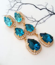 ✤ Can be made with any available crystal colors. Please contact me to check. ✤ Photos shown when worn are size demonstrations only. You will receive the colors shown in the first photo ✤ Size approx - Earrings are 65 mm long (2.6 inches) ✤ Matching bracelet available here: https://etsy.me/30jERom ✤ Matching necklace and hair comb can be made. Please contact me to check. ✤ Light weight ✤ Stud/Post Earrings. can be made with clip-ons, upon request. ✤ Made with CRYSTALLIZED™ - High-quality genuine Bridal Earrings Statement, Blue Bridal Earrings, Bridal Statement Earrings, Teal Ombre, Long Chandelier, Teal Earrings, Earrings Turquoise, Jewelry Essentials, Matching Bracelet