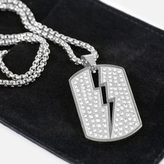 If you're looking to elevate your style on and off the playing field, the Trueno 1¾" Pendant with Chain Necklace is the perfect accessory. Crafted from high-quality stainless steel, this necklace not only adds a touch of elegance but is also designed to withstand the rigours of an athletic lifestyle. With options in polished 18K gold plating and silver, you can express your individuality or showcase your dedication to your favourite sport. The pendant is purpose-built for durability, ensuring it White Chain Necklace For Streetwear, Flame Necklace Men, Silver Dog Tag Ball Chain Necklace, Adjustable Punk Stainless Steel Necklace, Everyday Metal Dog Tag Necklace, Streetwear Stainless Steel Chain Necklace With Adjustable Chain, Football Chain Necklace, Silver Dog Tag Necklace With Ball Chain, Thunder Necklace